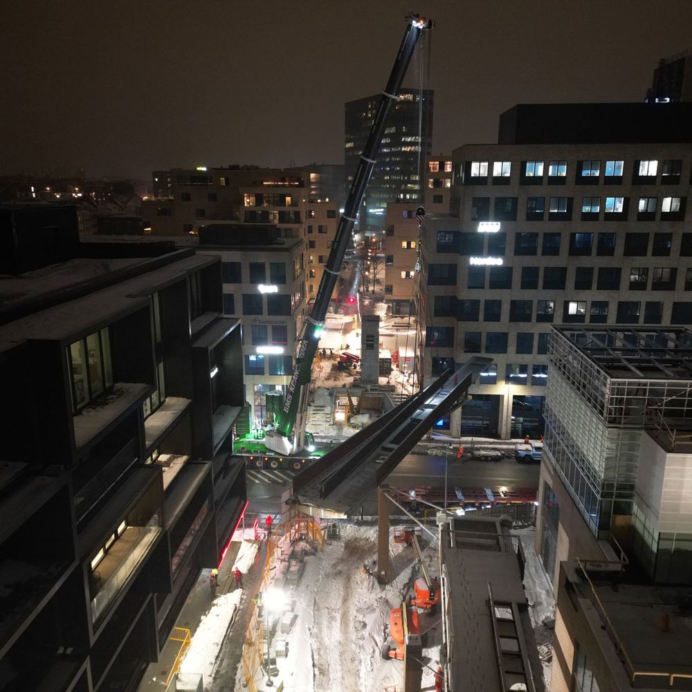 Mobilkran med lang bom mellem bygninger ved Kulbroen i Aarhus om natten